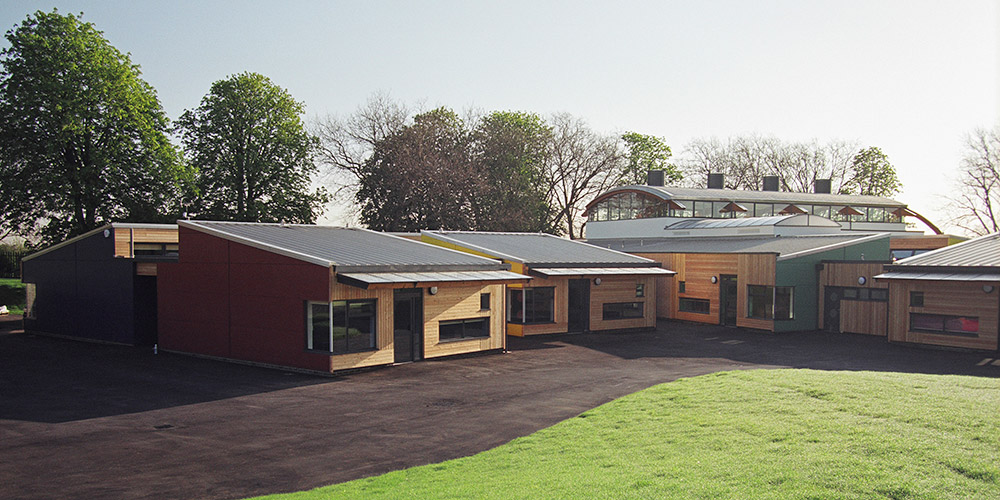 The new build primary school provides classrooms and facilities for 440 children. At the heart of the school is a top lit central area directly from the entrance designed as a gathering and meeting place. The structure of the building comprises steel and glulam frames with glulam ‘trees’ in the foyer and beams over the main hall incorporate passive roof ventilators. We provided all mechanical and electrical services including the design of the heating system, which is a sealed and pressurised system served by two gas-fired high efficiency modulating condensing boilers to produce low pressure hot water. 