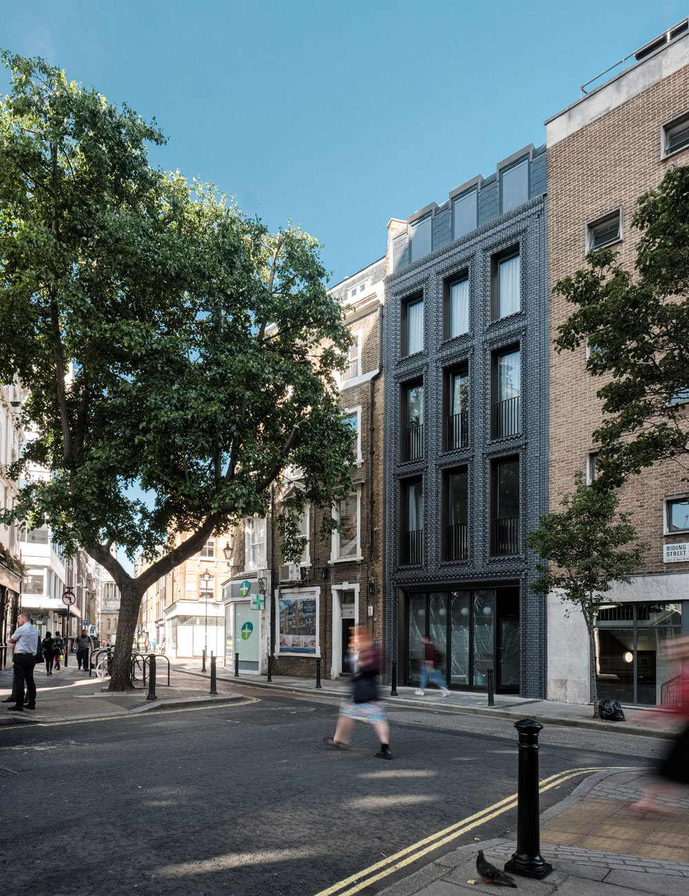 The Interlock is a new build five-storey mixed-use development designed to echo the proportions of the adjoining buildings, whilst challenging their traditional facades with matt blue clay bricks. Behind the façade, comprises three residential units, a ground floor cafe and subterranean gallery space for hosting exhibitions, workshops and talks.