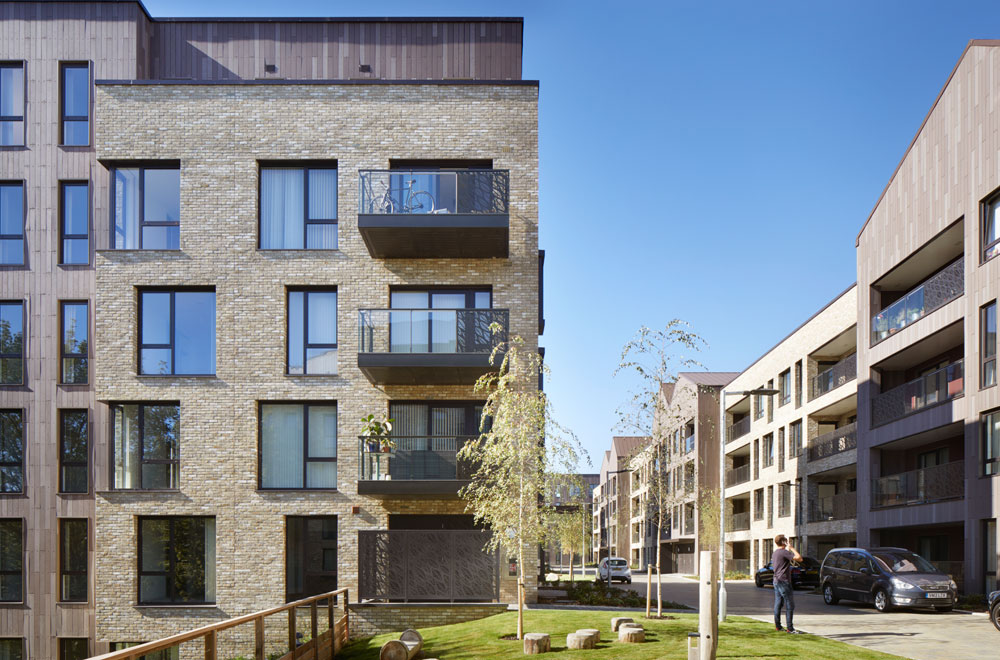 The Pavilions project provides 156 homes on a derelict railway embankment within a site of importance for nature conservation (SINC) on the edge of the King's Cross masterplan. The project comprises of seven residential buildings in a linear configuration alongside the railway, and a series of standalone pavilions on a vacant conservation area plot along Caledonian Road. The buildings are composed of interlocking forms clad in brick and glazed ceramic tiles with metal patterned detailing.