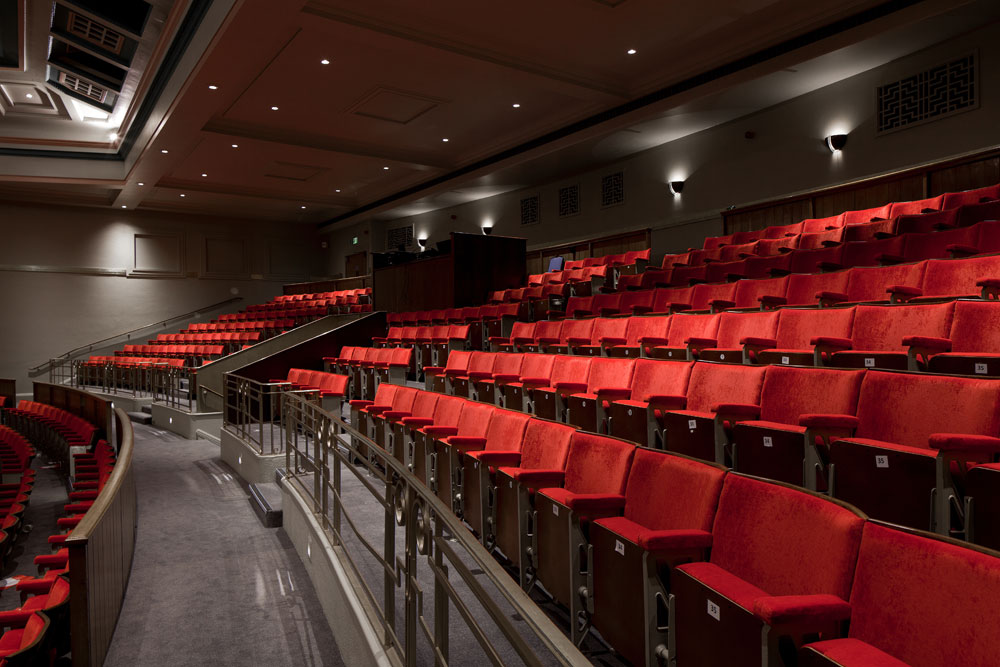 The refurbishment project restored the historic elements of the Grade II listed building while upgrading the infrastructure of the auditorium with modern audio-visual facilities and a large stage auditorium suitable for traditional theatre activities, teaching and examination space.