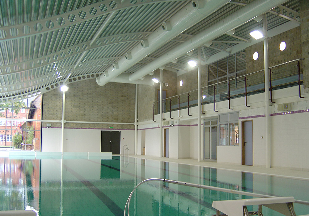 We provided all mechanical and electrical services for the new build school swimming pool on a sensitive site within existing school grounds. The project formed the first part of the school development plan, which included a new auditorium and sports hall. The terracotta clad building with contemporary curved roof houses a four lane 25m pool with fully accessible changing facilities with separate male and female changing and a viewing balcony.